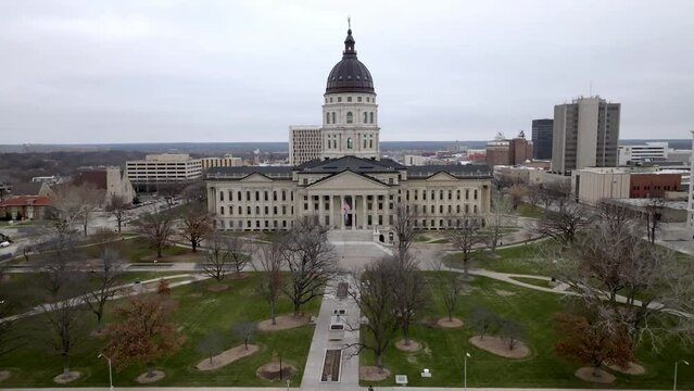 Kansas state capitol building in Topeka, Kansas with drone video moving up medium shot.
