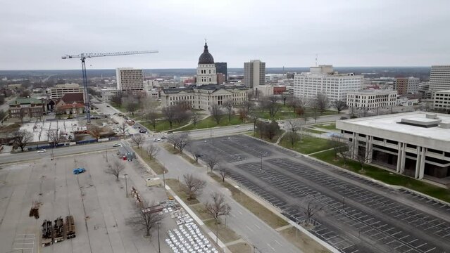 Kansas state capitol building in Topeka, Kansas with drone video moving at an angle wide shot.