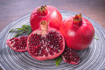 Pomegranate on wooden table background, Pomegranate with slices.