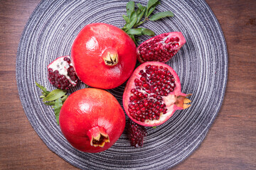 Pomegranate on wooden table background, Pomegranate with slices.