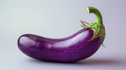 Glossy purple eggplant on a light background.
