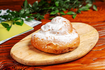 Dough roll on a wooden board.