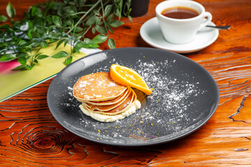 Pancakes with orange and butter cream. Breakfast.