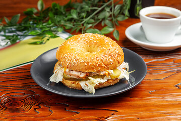 Bagel with chicken, cucumber and cabbage. Breakfast.