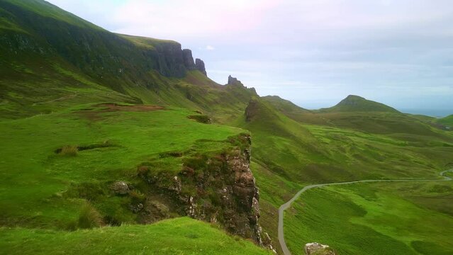 Aerial drone Isle of Skye in Scotland. Quiraing walk, mountain summit.
Scottish travel destination, tourism landmark in UK. Hiking in nature.