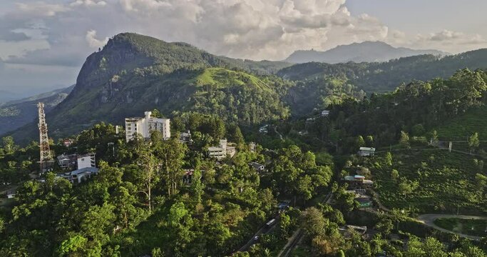 Ella Sri Lanka Aerial v1 panoramic panning shot capturing railway station, town center, hillside resort hotels and beautiful mountain landscape of rock point - Shot with Mavic 3 Cine - April 2023
