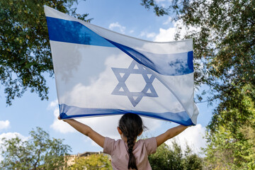 Back View On Child With Israeli Flag On Blue Sky, Clouds And Nature Background.