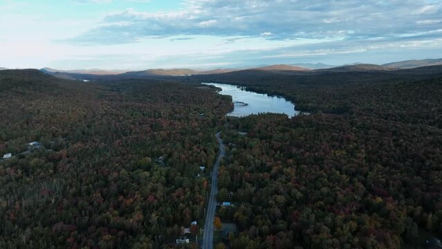 Boreal Forest In Autumn Foliage With View Of Road And Lake In Adirondack, New York. aerial shot