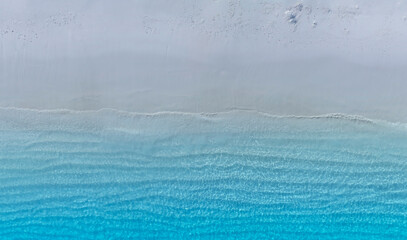 The soft wave water of the sea on the sandy beach background
