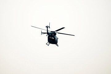 helicopter flying away on isolated white background