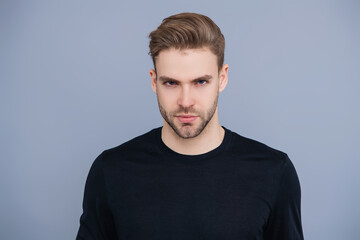 Skincare of men. Guy has stylish haircut. Man with trendy hairstyle. Casual male style. Young Caucasian man isolated on grey. Confident man face portrait. Men skin care. Magnetic Gaze