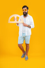 full length of man hold geometry protractor in studio. man hold geometry protractor