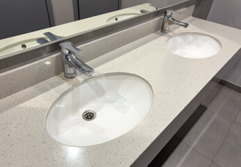 White washbasin with tap in the restroom