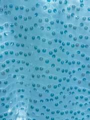 Glass drops on fabric as an abstract background. Texture
