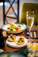 Restaurant table with appetizers and wine glasses