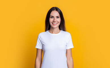 Woman isolated on yellow. Millennial woman wearing white tshirt. Casual style of millennial woman. Portrait of young woman in casual style tshirt in yellow studio - obrazy, fototapety, plakaty