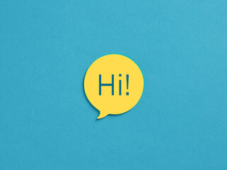The word Hi on yellow speech bubble over blue background.