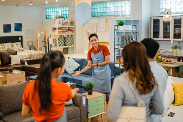 shop assistants let customers see new furniture products when customers come to the shop