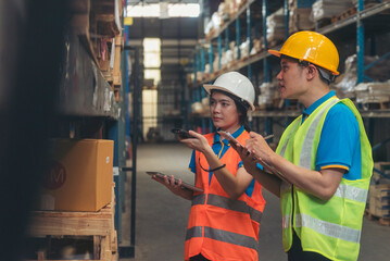 Asian men women worker use bar code scaner scan goods shelf writing checklist on clipboard....