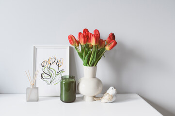 spring home decoration with flowers, bouquet of red tulips with handmade aquarelle poster on white background