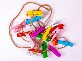 Multi-colored clothespins on a rope - 715301880