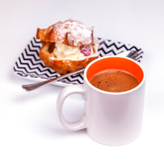 Cup with black coffee and tasty cake with cream on the table - 715302262