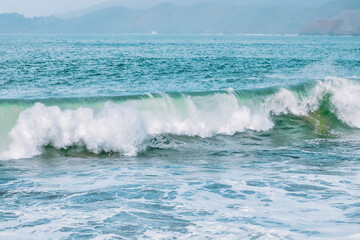 Wave splashing close-up. Crystal clear sea water, in the ocean in San Francisco Bay, blue water, pastel colors.