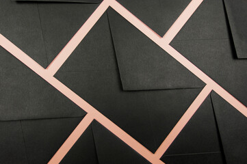 Top view of black envelopes on pink background. Post flat lay. Copy space.