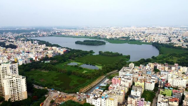 Aerial shot of BTM lake and city skyscrappers in background in Bangalore, Karnataka, India