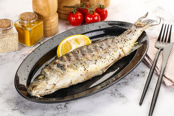 Grilled sea bass fish served lemon