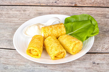 Stuffed pancakes with cream sauce