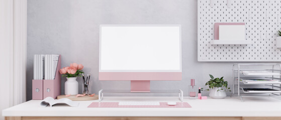 A beautiful pink female office desk with a modern pink computer and office supplies on the desk.