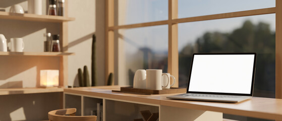 A white-screen laptop computer mockup on a kitchen countertop against the window on a sunny day.