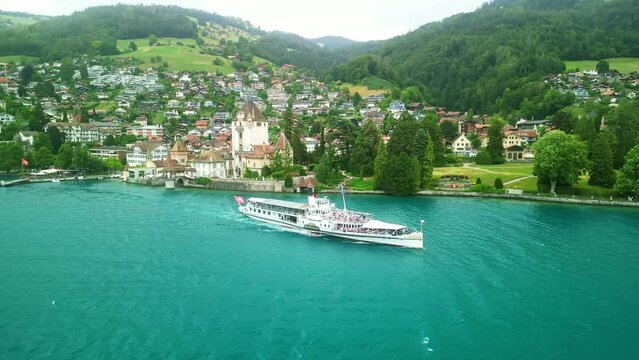Drone Switzerland 4k. Old steamboat ship tourist boat on lake Thun Brienz in Interlaken. Beautiful Swiss Alps mountains, alpine lake. Switzerland tourism in summer. 