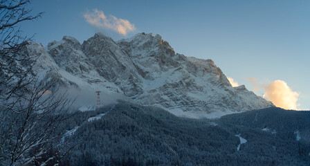 A bottom up view to the ice cold and with snow covered Zugspitze mountain chain and the surrounding...