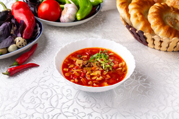 Red soup with vegetables. Eastern cuisine. Uzbek cuisine.