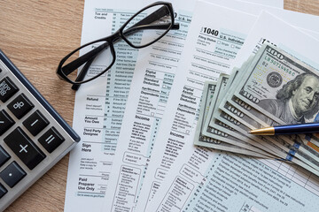 2023 tax form 1040 us  money and glasses, taxation concept