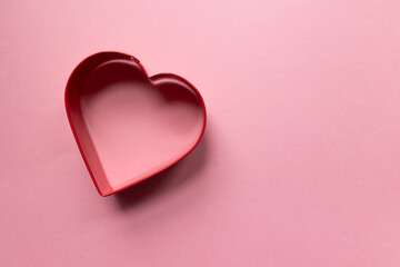 red heart outline against a pink background