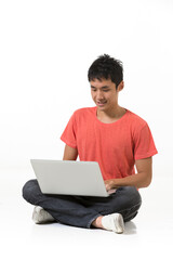 Happy Chinese man using a laptop PC.