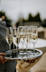 a tray of bubbling champagne flutes at a wedding reception