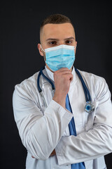 Portrait of caucasian professional doctor in protective cloth mask and gloves stethoscope isolated