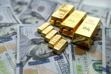 group gold bars and paper dollar bills as financial background