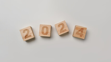 Wooden cube blocks with 2024 text on white background. New year business vision, goals and plans