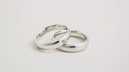 Two silver platinum wedding rings for husband and wife isolated on a white background