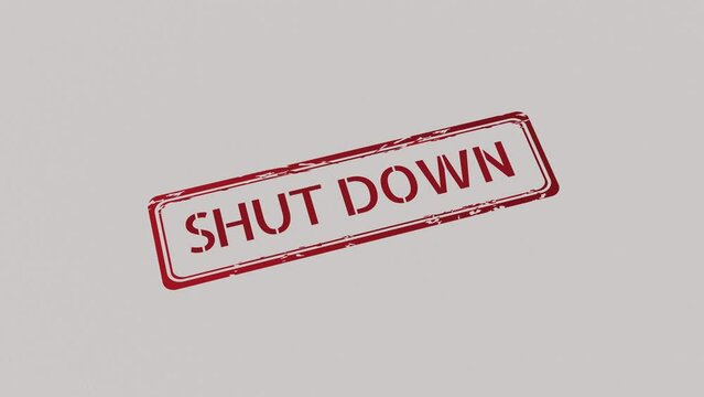 SHUT DOWN Stamp pressing on a paper