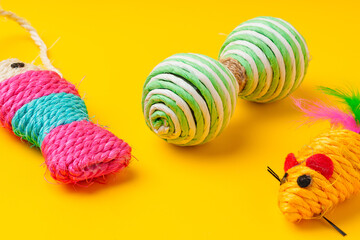Pet toys on yellow background studio shot