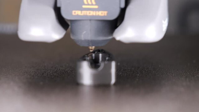 Close up static shot of object being printed on 3D printer