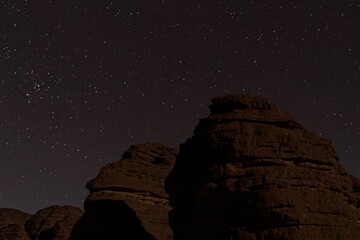The night sky and the Tikoubaouine rock formations in the tourist area of Immourouden, near the...