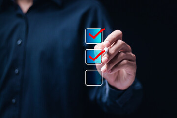 Checklist concept. Businessman using pen checking mark on checkboxes.