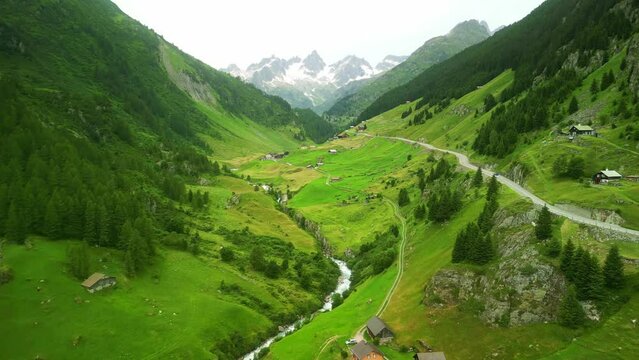Aerial drone view of scenic Oberalp pass drive in Swiss alps. Switzerland summer tourism destination. Alpine road trip road.